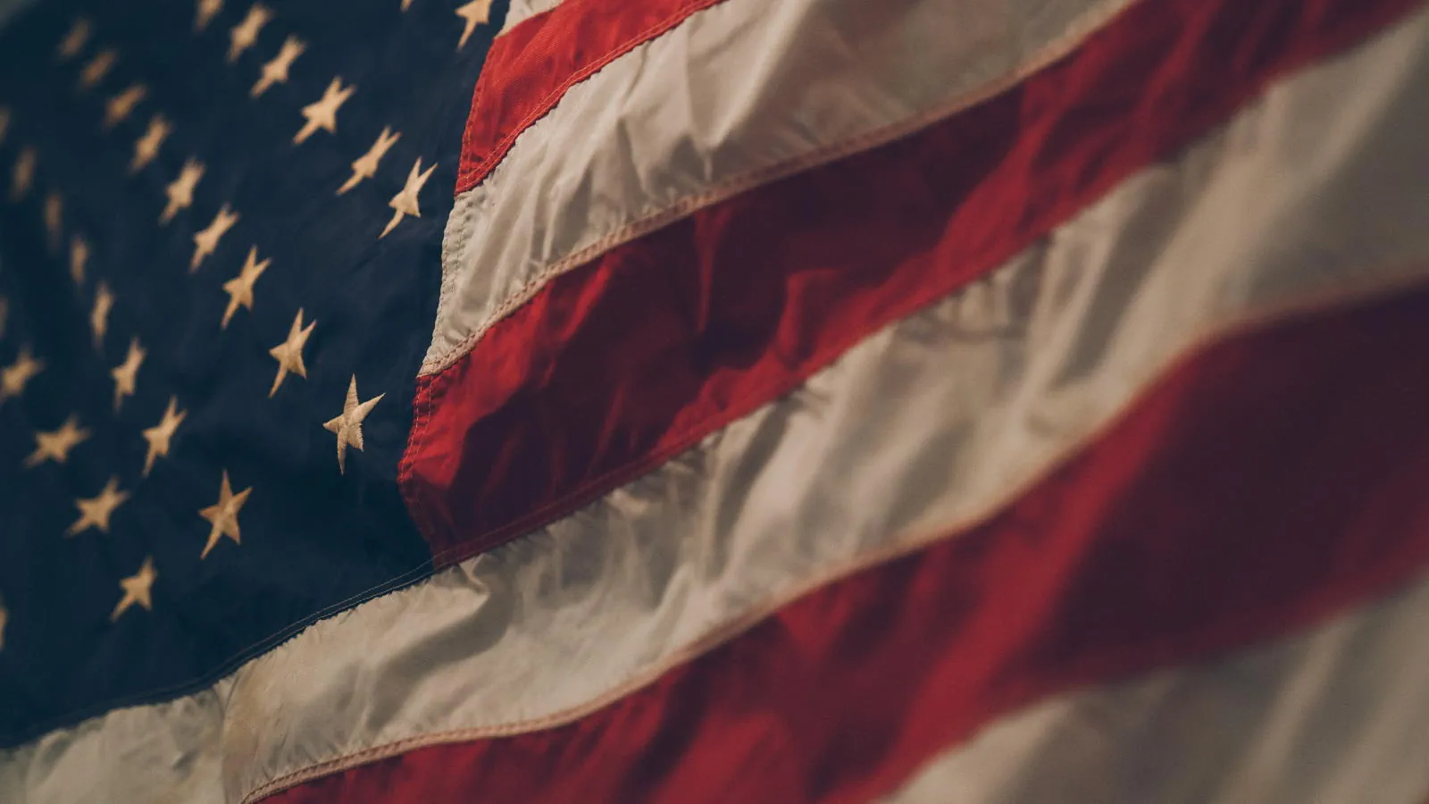 detail shot of an American flag rippling in a breeze