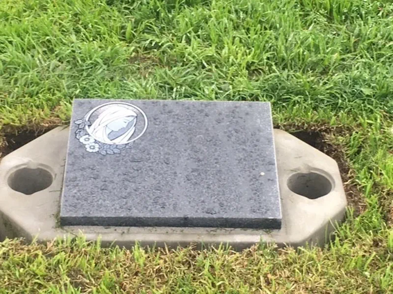 Small flat gray granite marker with 2 spaces to add flower vases.