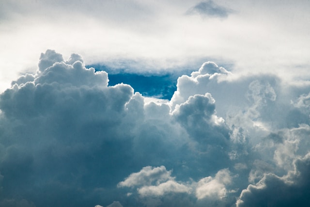 Cloudy sky above cemetery grounds representing eternal rest and reflection.